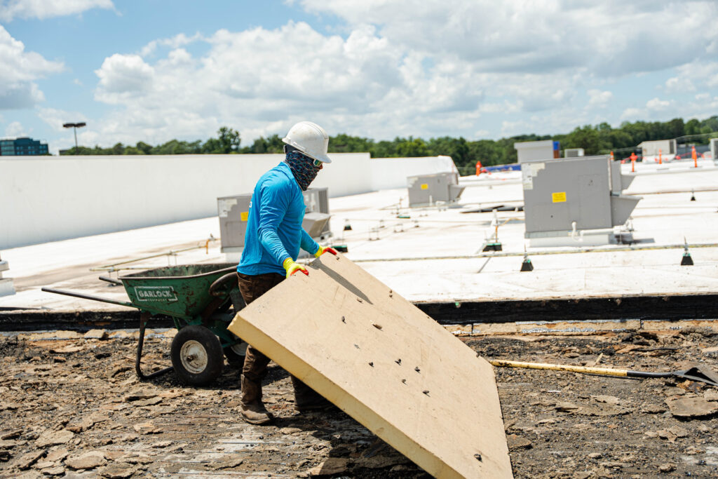 Cox Bros roofer working on a commercial building.
